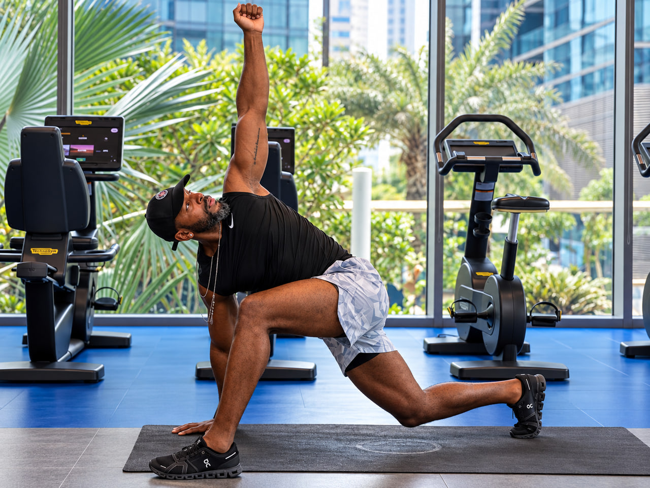 Coach Gari in a deep lunge with a twist, coaching movement and mobility